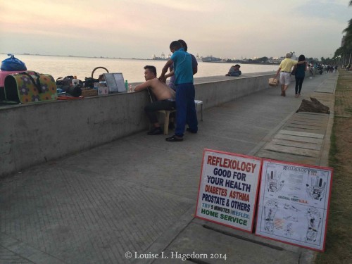 Getting a massage at sunset facing Manila Bay
